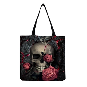 Close-up of gothic skull and red roses print on a high-capacity black tote bag