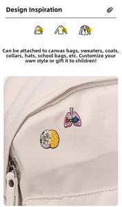 Cartoon enamel lung and brain pins with breathe text pinned on a canvas bag