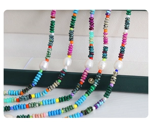 Detailed close-up of bohemian necklaces with colorful natural stones and irregular pearls