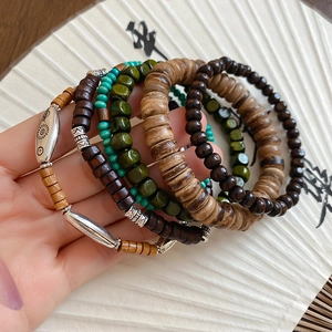 Detailed macro view of bohemian multilayer wood beads and carved ethnic metal spacers