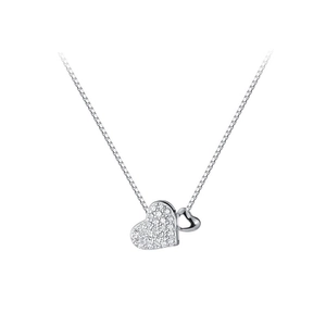 Macro shot of double heart pendant with pavé set cubic zirconia and polished box chain