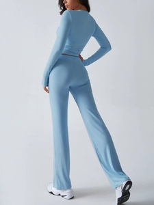 Rear view of a blue Y2K style slim fit long sleeve top and wide leg pants set for women