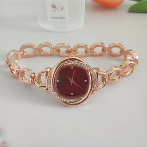Elegant rose gold watch for women featuring a red dial and crystal set flower metal strap