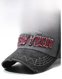 Close-up of vintage New York 1985 embroidery on washed cotton baseball cap with frayed edges