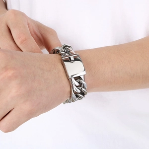 Close-up of 18mm silver Cuban link bracelet with heavy polished finish on male model