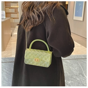 Detail of lime green quilted jelly bag with bead handle and gold chain strap