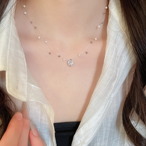 Close-up of double-layer necklace with pearl accents and sparkling round zircon pendant