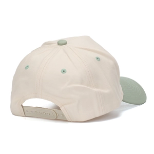 Adjustable snapback closure on a two-tone cotton baseball cap with cream and green panels