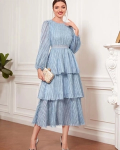 Detail of light blue tiered dress featuring unique fringe texture and long sleeves