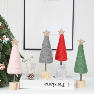 Mini felt Christmas trees with gold stars and wooden bases in pink, green, and gray
