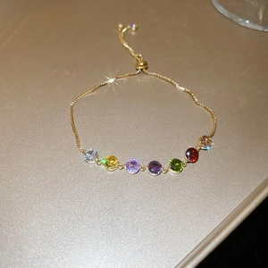 French style gold bracelet with seven colorful cubic zirconia stones and adjustable bolo clasp