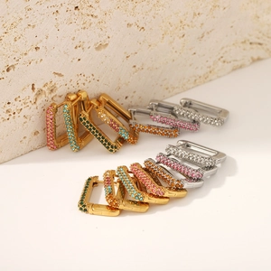 Detail of square gold-plated earrings featuring multicolored micro-pave cubic zirconia