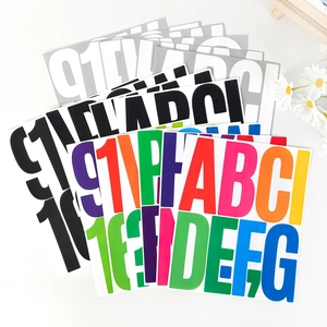 Detailed close-up of 5-inch colorful alphanumeric stickers in assorted vibrant glossy finishes