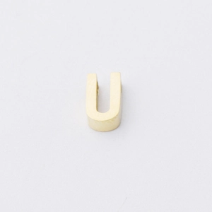 Detailed view of mirror polished golden stainless steel letter U bead for jewelry