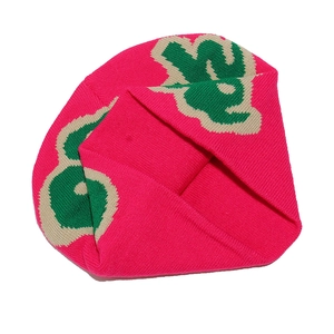 Flat lay of pink knit beanie with abstract floral patterns and woven texture detail