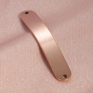 Macro detail of curved rose gold brushed titanium steel pendant connector with dual holes