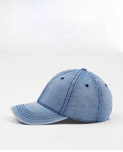 Side view of washed denim baseball cap with reinforced stitching and vintage texture