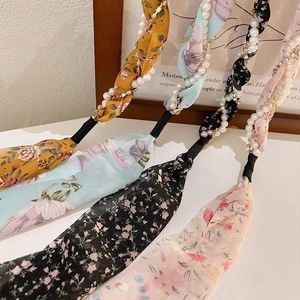 Floral print headbands with pearl strands and elastic bands in multiple colors