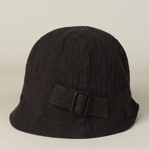 Detail of dark brown linen bucket hat with textured vertical ridges and side buckle