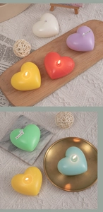 Macro detail of heart-shaped scented candles in multiple colors on elegant trays