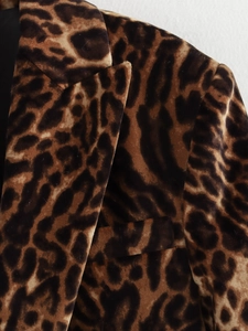 Detailed macro view of the leopard print blazer's velvet texture and collar design