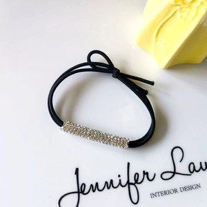 Black elastic hair tie with a rectangular silver rhinestone bar for a stylish ponytail