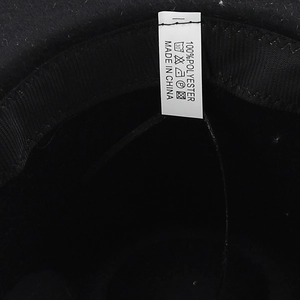 Detail of jazz hat interior showing 100% polyester material and washing label