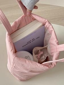Pink quilted puffer handbag for women with large capacity shown with daily essentials