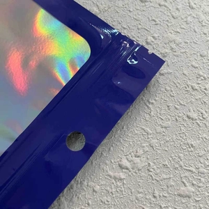 Close-up of blue holographic pouch with clear window, zipper seal, and hanging hole