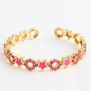 Detailed view of adjustable gold-plated ring with pink enamel stars and zircon stones