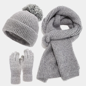 Three-piece winter knit set with thick gray pom pom hat scarf and matching gloves