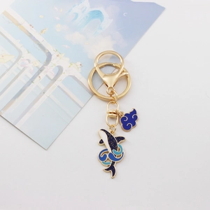 Detail of whale and cloud keychain charms with blue enamel and sparkling glitter