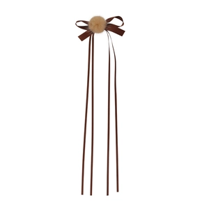 Ballet style brown ribbon bow hair clip with beige pompom and long streamers on white