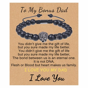 Detail of matte black onyx beads and lion head charm on adjustable gift card bracelet
