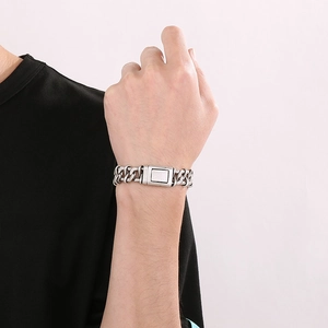 Close-up of men's matte silver titanium steel thick curb chain bracelet on wrist