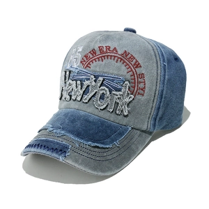 Detail of vintage washed baseball cap featuring 3D New York embroidery and distressed brim