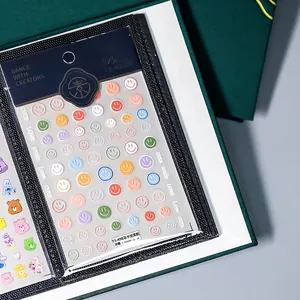 Nail sticker storage album showing macaron smiley face embossed decals in TS-498 style