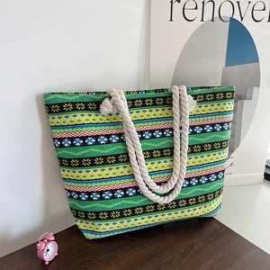 Ethnic geometric canvas tote bag with beige rope handles on a wooden table