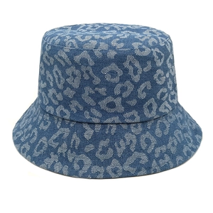 Detailed view of blue denim bucket hat featuring leopard print and durable stitched brim