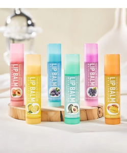 Detailed set of 6 fruit-flavored lip balms with vitamin E on a wooden base