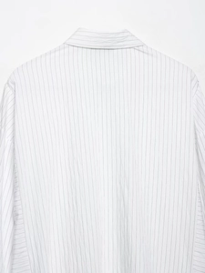 Detail of white striped shirt back showing fine sewing and natural fabric texture
