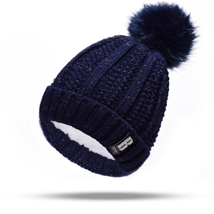 Detail showing the thick faux shearling lining and navy knit texture of the beanie hat