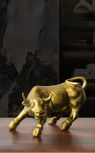 Macro detail of golden bull figurine made of premium resin on a wooden desk