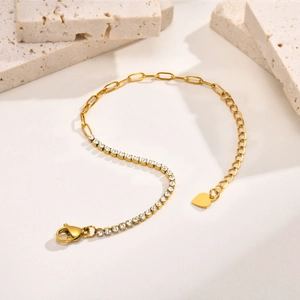Gold stainless steel link bracelet with square zircons and heart charm on decorative stone