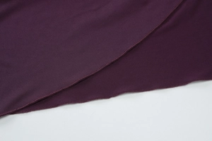 Close-up of deep purple fabric showing detailed hem stitching and high-quality texture