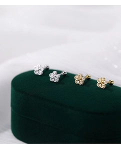 Macro detail of S925 sterling silver flower earrings with zircon in a velvet box