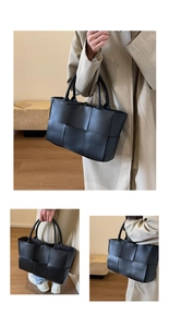 Detail shot of the woven texture and craftsmanship on a large black tote shoulder bag
