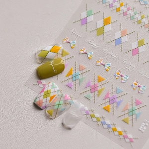 Close-up of colorful argyle and bow pattern nail stickers for elegant DIY manicure art