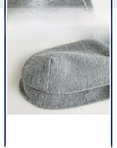 Detail of reinforced heel and seamless toe stitching on grey cotton business socks