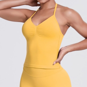 Detail view of the yellow seamless knit yoga top featuring a halter neck and V-neckline